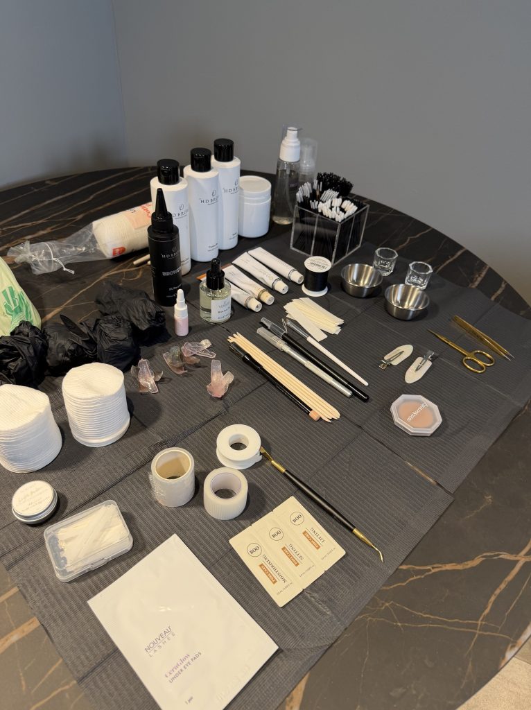 Brow treatment kit laid out on a table, including HD Brows products
